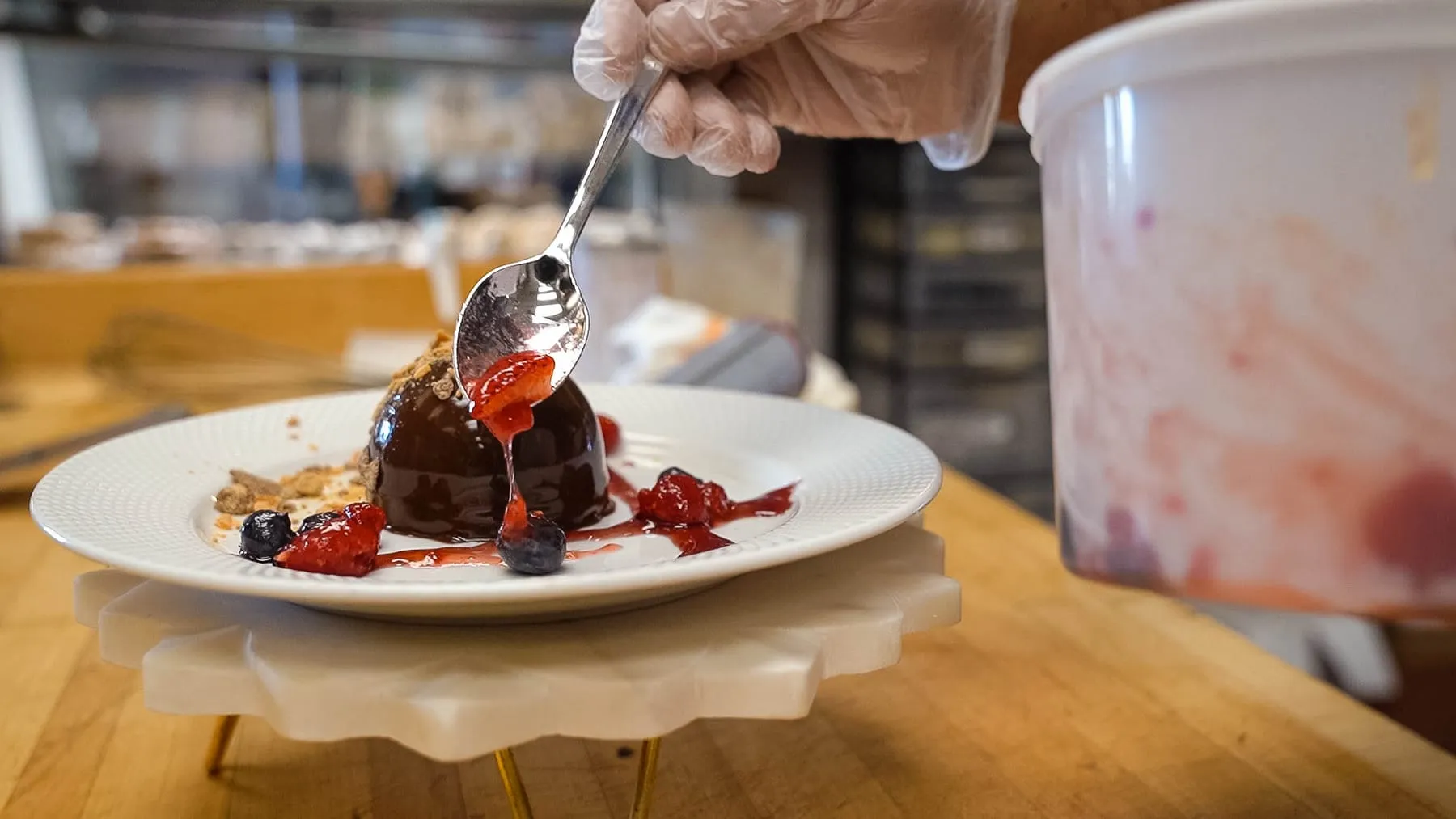 Adding strawberry sauce to a Peanut Butter Bomb